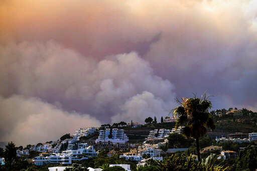 A wildfire advances near the urbanisation in Marbella, Malaga, on Thursday, June 9, 2022. Emergency services deployed almost 1,000 firefighters, military personnel and support crews Thursday to fight a wildfire that has forced the evacuation of some 2,000 people in southern Spain amid fears that torrid weather may feed the blaze. (AP Photo/Gregorio Marrero)