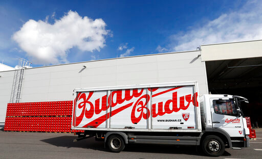 FILE - A truck drives past cases of beer at the Budejovicky Budvar brewery in Ceske Budejovice, Czech Republic, on March 11, 2019. Budvar, the Czech brewer that has been in a long legal dispute with U.S. company Anheuser-Busch over use of the &ldquo;Budweiser&rdquo; brand, has increased its beer exports last year despite the pandemic. Budejovicky Budvar NP, a 126-year-old state-owned brewery, said on Monday its exports were up a record of 11% in 2021, reaching 1.3 million hectoliters (34.3 million gallons).  (AP Photo/Petr David Josek, File)