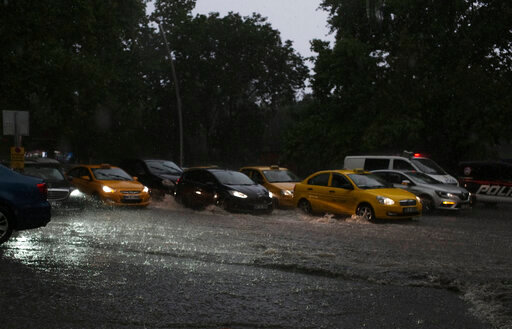 A traffic jam in a flooded street in the city center of Ankara, Turkey, Saturday, June 11, 2022. Heavy rainfall in Turkey's capital on Saturday led to flooding that killed one person, authorities said. Ankara Mayor Mansur Yavas tweeted that 35 people had been rescued. He reported flooding in 300 locations, 35 fallen trees and the collapse of 23 roofs and three utility poles. (AP Photo/Burhan Ozbilici)