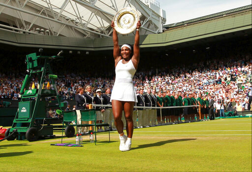 FILE - Serena Williams of the United States holds up the trophy after winning the women's singles final against Garbine Muguruza of Spain at the All England Lawn Tennis Championships in Wimbledon, London, Saturday, July 11, 2015. Chris Evert appreciates that she, Serena Williams and other Wimbledon women's singles champions will now be listed on the All England Club's honor boards in a Centre Court hallway simply by their first initial and last name &mdash; the way the men's title winners always have been &mdash; instead of preceded by &ldquo;Miss&rdquo; or &ldquo;Mrs.&rdquo;(Sean Dempsey/Pool via AP, File)