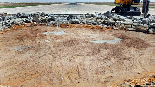 This photo released Sunday June 12, 2022 by the Syrian official news agency SANA, shows a bulldozer work at a damaged runway of the Damascus International Airport, which was hit by an Israeli airstrike on Friday, in Damascus, Syria. Syria's Transportation Ministry said the Israeli airstrike caused &quot;significant&quot; damage to infrastructure and rendered the main runway unserviceable until further notice. (SANA via AP)