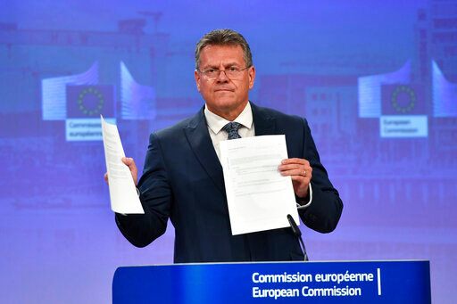 European Commissioner for Inter-institutional Relations and Foresight Maros Sefcovic holds up documents as he speaks during a media conference at EU headquarters in Brussels, Wednesday, June 15, 2022. Britain's government on Monday proposed new legislation that would unilaterally rewrite post-Brexit trade rules for Northern Ireland, despite opposition from some U.K. lawmakers and EU officials who say the move violates international law. (AP Photo/Geert Vanden Wijngaert)