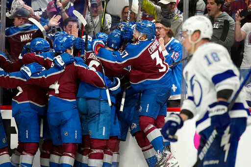 The Colorado Avalanche celebrate after an overtime goal by Andre Burakovsky in Game 1 of the NHL hockey Stanley Cup Final against the Tampa Bay Lightning on Wednesday, June 15, 2022, in Denver. (AP Photo/John Locher )