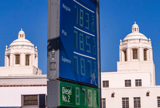 FILE - Various grades of gasoline, with prices above seven dollars per gallon, are displayed at a Chevron gas station, May 22, 2022, in downtown Los Angeles. Americans cut their spending unexpectedly in May compared with the month before, underscoring how surging inflation on daily necessities like gas is causing them to be more cautious about buying discretionary items. (AP Photo/Damian Dovarganes, file)