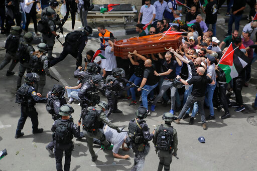 FILE - Israeli police confront with mourners as they carry the casket of slain Al Jazeera veteran journalist Shireen Abu Akleh during her funeral in east Jerusalem, Friday, May 13, 2022. An Israeli police investigation reveals that police engaged in misconduct during the funeral of Abu Akleh. Those who supervised the event will not face serious punishment, according to an Israeli daily newspaper report published on Thursday, June 16, 2022. (AP Photo/Maya Levin, File)