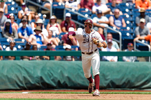 Texas A&amp;M third baseman Trevor Werner throws to first for an out against Texas in the first inning during an NCAA College World Series baseball game Sunday, June 19, 2022, in Omaha, Neb. (AP Photo/John Peterson)