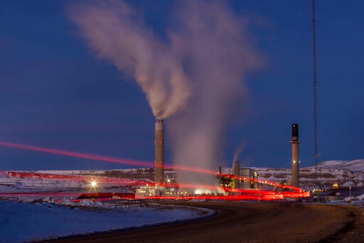 FILE - In this photo taken with a slow shutter speed, taillights trace the path of a motor vehicle at the Naughton Power Plant, Thursday, Jan. 13, 2022, in Kemmerer, Wyo. While the power plant will be closed in 2025, Bill Gates' company TerraPower announced it had chosen Kemmerer for a nontraditional, sodium-cooled nuclear reactor that will bring on workers from a local coal-fired power plant scheduled to close soon. The U.S. nuclear industry has provided a steady 20% of the nation's power for years, but now plant operators are hoping to nearly double their output over the next three decades, according to the industry's trade association. (AP Photo/Natalie Behring, File)