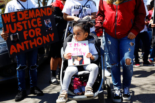 FILE - In this Saturday, May 1, 2021 file photo, Ailani Alvarez, 2, daughter of Anthony Alvarez who was shot by the police, holds a sign reading &quot;I miss my daddy&quot; during a protest in Chicago. Chicago police officers will no longer be allowed to chase people on foot simply because they run away or give chase over minor offenses, the department said Tuesday, June 21, 2022, more than a year after two foot pursuits ended with officers fatally shooting a 13-year-old boy and 22-year-old man. (AP Photo/Shafkat Anowar, File)