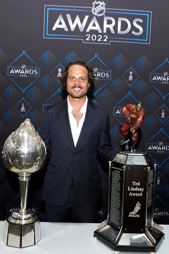 Toronto Maple Leafs center Auston Matthews poses with the Hart Trophy, left, and Ted Lindsay Award after the NHL hockey awards Tuesday, June 21, 2022, in Tampa, Fla. The Hart Trophy is presented annually to the leagues' most valuable player and the Ted Lindsay award is giving the the most outstanding player. (AP Photo/John Bazemore)