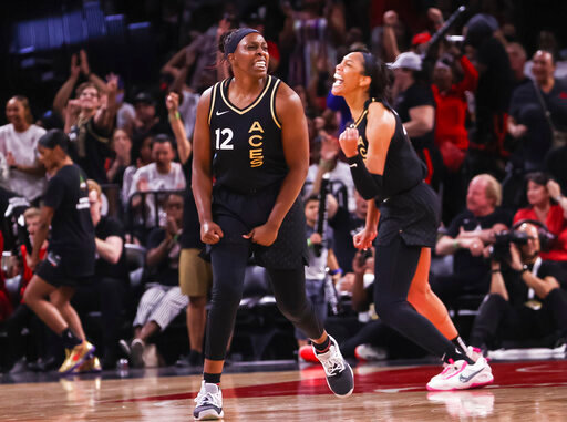 Las Vegas Aces guard Chelsea Gray (12) and forward A'ja Wilson celebrate after a play against the Minnesota Lynx during the second half of a WNBA basketball game Sunday, June 19, 2022, in Las Vegas. (Chase Stevens/Las Vegas Review-Journal via AP)