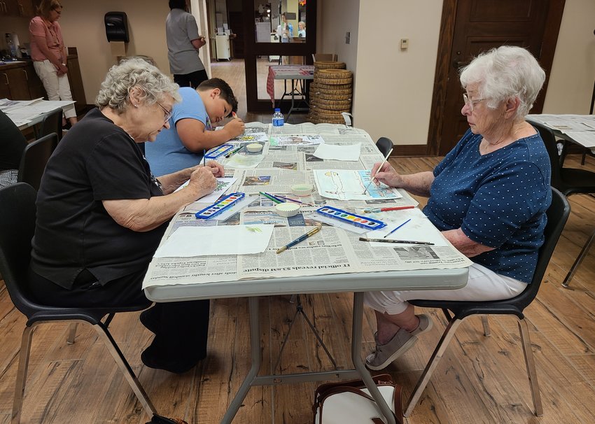 Alex Woollard, Linda Decker, and Mona Kubler create water color pictures at the Pittsburg Public Library&rsquo;s iCraft event on Wednesday. The library hosts its iCraft events, which are free to the public, once a month, providing a creative outlet for ages 6th grade and up.