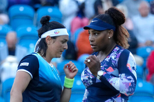 Serena Williams of the United States and Ons Jabeur of Tunisia speak before playing a point against Shuko Aoyama of Japan and Hao-Ching of Taiwan during their quarterfinal doubles tennis match at the Eastbourne International tennis tournament in Eastbourne, England, Wednesday, June 22, 2022. (AP Photo/Kirsty Wigglesworth)