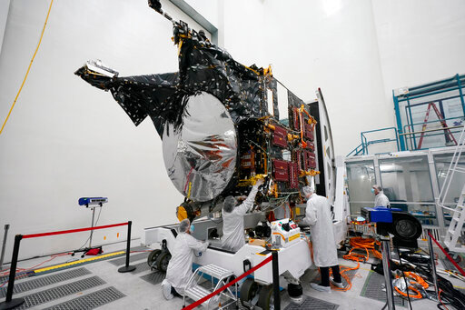 FILE - Technicians work on the Psyche spacecraft at the NASA Jet Propulsion Laboratory, April 11, 2022, in Pasadena, Calif. NASA put an asteroid mission on hold Friday, June 24, 2022, blaming the late delivery of its own navigation software. The Psyche mission to a strange metal asteroid of the same name was supposed to launch this September or October. But the agency&rsquo;s Jet Propulsion Lab was several months late writing and delivering its software for navigation, guidance and control. (AP Photo/Marcio Jose Sanchez, File)