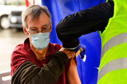 FILE - Crager Boardman, from Brattleboro, Vt., receives a shot at a flu vaccine clinic in Brattleboro on Tuesday, Oct. 26, 2021. On Wednesday, June 22, 2022, a federal advisory panel says Americans 65 and older should get newer, souped-up flu vaccines. The panel unanimously recommended certain flu vaccines for seniors, whose weakened immune systems don&rsquo;t respond as well to traditional shots. (Kristopher Radder/The Brattleboro Reformer via AP, File)