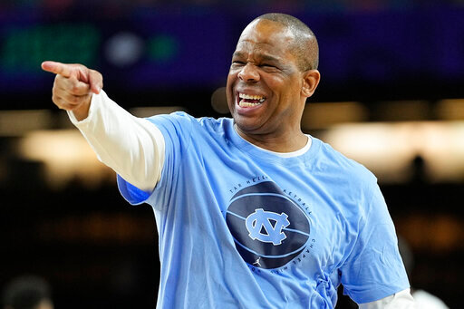 FILE - North Carolina head coach Hubert Davis points during practice at the men's Final Four NCAA college basketball tournament, on April 1, 2022, in New Orleans. National runner-up North Carolina, a strong contender for the No. 1 spot in the preseason polls with four starters returning, will play at Indiana in the ACC/Big Ten Challenge on Nov. 30. (AP Photo/David J. Phillip, File)