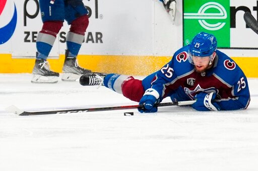 Colorado Avalanche right wing Logan O'Connor (25) tries to control the puck from the ice during the second period in Game 5 of the team's NHL hockey Stanley Cup Final against the Tampa Bay Lightning, Friday, June 24, 2022, in Denver. (AP Photo/Jack Dempsey)
