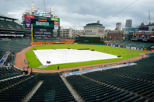 The Comerica Park infield is covered prior to the baseball game between the Detroit Tigers and the Cleveland Guardians was postponed because of rain, Friday, May 27, 2022, in Detroit. (AP Photo/Carlos Osorio)