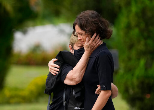 Alessandra Sampaio, right, is comforted during the funeral of her husband British journalist Dom Phillips at the Parque da Colina cemetery in Niteroi, Brazil, Sunday, June 26, 2022. Family and friends paid their final respects to Phillips who was killed in the Amazon region along with the Indigenous expert Bruno Pereira. (AP Photo/Silvia Izquierdo)