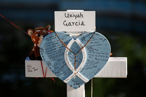 Uziyah Garcia's cross stands at a memorial site for the victims killed in this week's shooting at Robb Elementary School in Uvalde, Texas, Friday, May 27, 2022. (AP Photo/Dario Lopez-Mills)