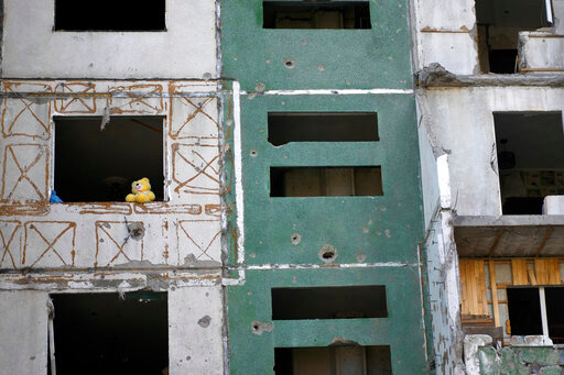 A teddy bear is seen on a building destroyed by attacks in Chernihiv, Ukraine, Sunday, June 19, 2022. (AP Photo/Natacha Pisarenko)