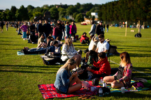 People queue after camping overnight before the start of day one of the Wimbledon tennis championships in London, Monday, June 27, 2022. (Aaron Chown/PA via AP)