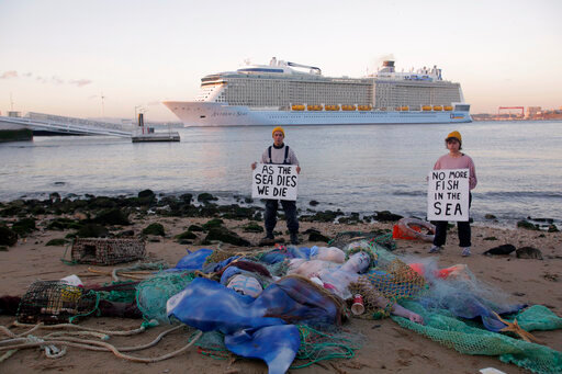 EDS NOTE: NUDITY - Ocean Rebellion activists stage a performance calling for an end to all national fuel subsidies to fishing fleets and bans to bottom trawling, at the Tagus river bank in Lisbon, Monday, June 27, 2022. From June 27 to July 1 the United Nations is holding its Oceans Conference in Lisbon expecting to bring fresh momentum for efforts to find an international agreement on protecting the world's oceans. (AP Photo/Ana Brigida)