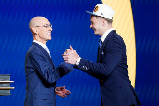 Christian Braun, right, is congratulated by NBA Commissioner Adam Silver after being selected 21st overall by the Denver Nuggets in the NBA basketball draft, Thursday, June 23, 2022, in New York. (AP Photo/John Minchillo)