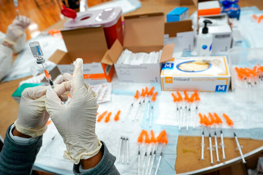 FILE - A Northwell Health registered nurse fills a syringe with a COVID-19 vaccine at a pop up vaccination site the Albanian Islamic Cultural Center, April 8, 2021, in the Staten Island borough of New York. The Food and Drug Administration on Thursday, June 30, 2022 recommended that COVID-19 booster shots be modified to better match more recent variants of the coronavirus. (AP Photo/Mary Altaffer, file)