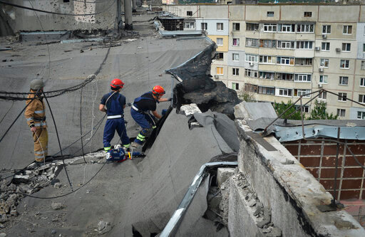 Ukrainian rescuers dismantle the roof of a high-rise building damaged by Russian shelling in one of the residential areas of Kharkiv, Ukraine, Thursday, June 30, 2022. (AP Photo/Sofiia Bobok)
