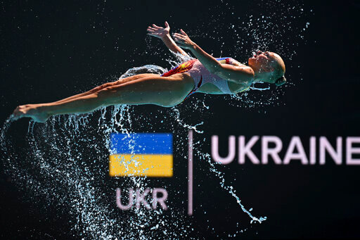 A member of Team Ukraine competes during the final of highlights of the artistic swimming at the 19th FINA World Championships in Budapest, Hungary, Saturday, June 25, 2022. (AP Photo/Anna Szilagyi)