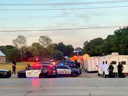 Law enforcement work the scene where multiple shots were fired near the area of Cedarcrest Drive and Diamond Oaks Drive in Haltom City, Texas, Saturday, July 2, 2022.  (James Hartley/Star-Telegram via AP)