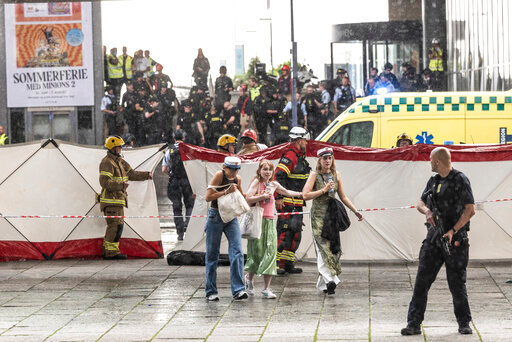 People leave the Field's shopping center in Copenhagen, Denmark Sunday, July 3, 2022. A gunman opened fire inside the busy shopping mall in the Danish capital Sunday, killing a few people and critically wounding a few others, police said. (Olafur Steinar Rye Gestsson/Ritzau Scanpix via AP)
