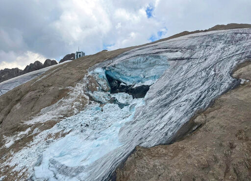 This undated image made available Monday, July 4, 2022, by the press office of the Autonomous Province of Trento shows the glacier in the Marmolada range of Italy's Alps near Trento from which a large chunk has broken loose Sunday, killing at least six hikers and injuring eight others. Drones were being used to spot any more bodies on an Italian Alpine mountainside a day after a huge chunk of a glacier broke loose, sending an avalanche of ice, snow, and rocks onto hikers. Rescuers on Sunday spotted six bodies and said nine survivors were injured. Attention on Monday was focused on determining how many people who might have been hiking on the Marmolada peak are unaccounted for. Rescuers said conditions downslope from the glacier, which has been melting for decades, were still too unstable to immediately send rescuers and dogs into the area to look for others buried under tons of debris.  (Autonomous Province of Trento via AP)