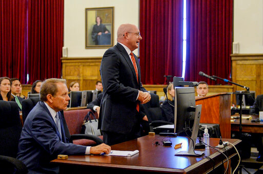Attorney Paul T. Ferrell Jr. asks West Virginia Circuit Court Judges Alan Moats and Derick Swope for a continuance in the opioid trial scheduled to begin Tuesday, July 5, 2022, in the Kanawha County Ceremonial Courtroom in Charleston, W.Va. Lawyer Bob Fitzsimmons sits at the table to Ferrell's right. (Chris Dorst/Charleston Gazette-Mail via AP)