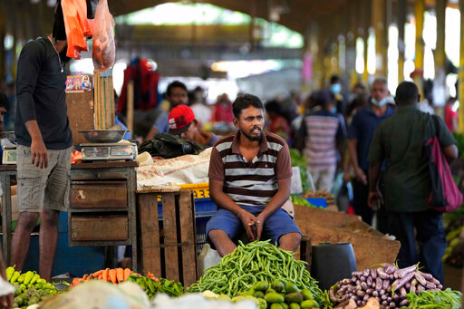 FILE - A vender waits for customers at a vegetable market place in Colombo, Sri Lanka, Friday, June 10, 2022. Some 1.6 billion people in 94 countries face at least one dimension of the crisis in food, energy and financial systems, according to a report last month by the Global Crisis Response Group of the United Nations Secretary-General. (AP Photo/Eranga Jayawardena, File)