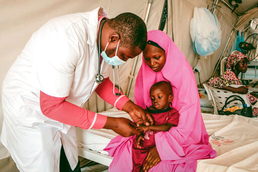 M&eacute;decins Sans Fronti&egrave;res 'MSF' doctor Ibrahim Fori Bwala, left, examines Ja'afar Ahmed, a malnourished child at the Inpatients Therapeutic Feeding Center in Maiduguri, Nigeria, Friday, June 10, 2022. Nigeria is grappling with child malnutrition in its troubled northwest region where armed groups have been targeting rural communities. The food crisis is worsened by an already existing hunger in this part of the West African nation which government statistics say has a 40% poverty rate. (Nasir Ghafoor/M&eacute;decins Sans Fronti&egrave;res via AP)