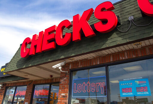 All Checks Cashed in Everett, Mass., is seen, April 21, 2022. All Checks Cashed is one of nearly 150 businesses licensed by the state of Massachusetts to cash checks and sell lottery tickets. Check cashers sold nearly $36 million in lottery products from 2017 through 2020. (Garrett Adamtsev/Boston University/The Howard Center for Investigative Journalism via AP)