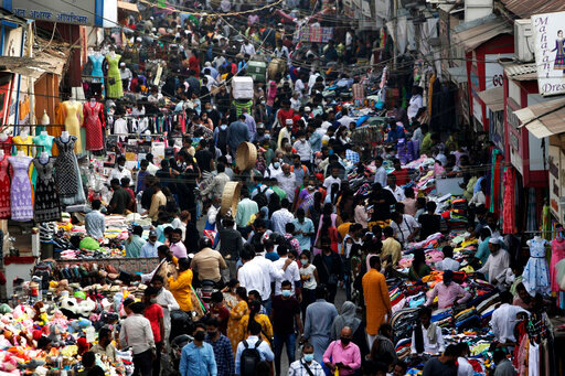 FILE - Indians wearing face masks as a precaution against the COVID-19, crowd a market, in Mumbai, India, on Jan. 7, 2022. The United Nations estimated Monday, july 11, 2022 that the world&rsquo;s population will reach 8 billion on Nov. 15 and that India will replace China as the world&rsquo;s most populous nation next year. (AP Photo/Rajanish Kakade, File)