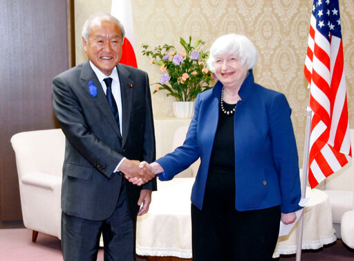 U.S. Treasury Secretary Janet Yellen, right, and Japan's Finance Minister Shunichi Suzuki shake hands during their meeting at the finance ministry in Tokyo, Tuesday, July 12, 2022. Yellen said Tuesday collaboration with Japan was pivotal for the war in Ukraine, free trade and efforts on sustainable energy and food security. (Kyodo News via AP)