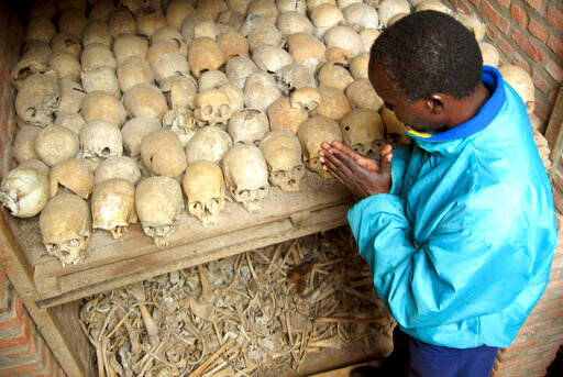 CAPTION OMITS LINE ABOUT MASS GRAVE FILE&mdash;A Rwandan survivor of the 1994 Genocide prays over the bones of genocide victims at a mass grave in Nyamata, Rwanda April 6, 2004. Genocide survivors in Rwanda welcomed the conviction in France of Laurent Bucyibaruta, a former official in this East African country whose current leaders are pressing for the arrest and trial of all genocide suspects still at large in Europe. (AP Photo/Sayyid Abdul Azim-file)
