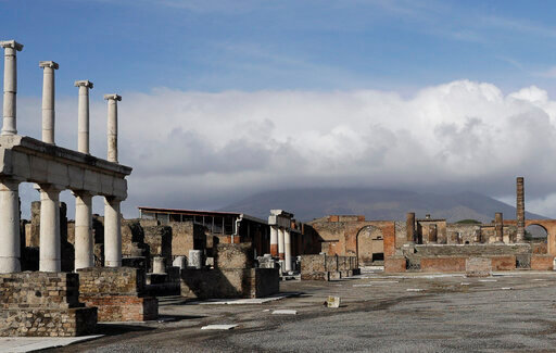 FILE - Clouds hang over the Vesuvius volcano in Pompeii, southern Italy, Jan. 25, 2021. An American tourist had to be rescued on Mount Vesuvius near Naples after he apparently slipped into the volcano&rsquo;s crater while trying to recover his fallen cellphone, news reports and the association of Vesuvius park guides said. The tourist and family members were cited by Carabinieri police because they went off the authorized path to get closer to the crater on Saturday, July 9, 2022 apparently to take a selfie, Italian news reports said. (AP Photo/Gregorio Borgia, file)