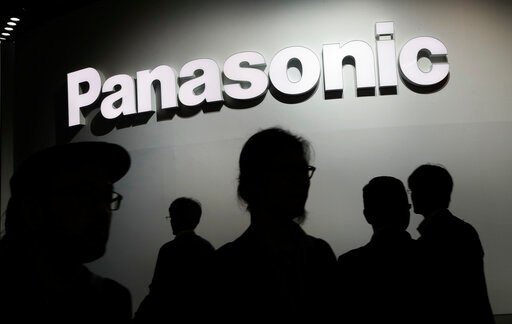 FILE - People walk by the Panasonic booth during CES International, on Jan. 9, 2018, in Las Vegas. Japan&rsquo;s Panasonic Corp. selected Kansas as the location for a multibillion-dollar mega-factory to produce electric vehicle batteries for Tesla and other carmakers, Gov. Laura Kelly announced Wednesday, July 13, 2022. (AP Photo/John Locher, File)