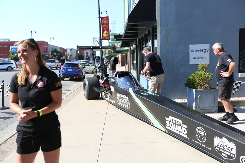 Megan Meyer Lingner poses at Block 22 in downtown Pittsburg next to her new nitro injected dragster, with a top speed of 285 miles per hour.