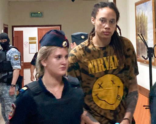 WNBA star and two-time Olympic gold medalist Brittney Griner is escorted to a courtroom for a hearing in the Khimki district court, just outside Moscow, Russia, Friday, July 15, 2022. Griner was arrested in February at the Russian capital's Sheremetyevo Airport when customs officials said they found vape canisters with cannabis oil in her luggage. She has been jailed since then, facing up to 10 years in prison if convicted. (AP Photo/Jim Heintz)