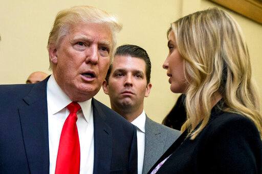 FILE - Donald Trump, left, his son Donald Trump Jr., center, and his daughter Ivanka Trump speak during the unveiling of the design for the Trump International Hotel, in Washington, Sept. 10, 2013. Former President Trump and two of his children got their questioning postponed Friday, July 15, 2022, in a New York civil investigation into their business dealings, a delay that follows the death of Trump&rsquo;s ex-wife Ivana.  (AP Photo/Manuel Balce Ceneta, File)