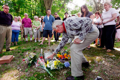 FILE &mdash; Howard Mott reaches for Princess Doe's gravestone during a memorial service at Cedar Ridge Cemetery in Blairstown, N.J., July 15, 2007. The remains of a young girl who was dubbed &ldquo;Princess Doe&rdquo; after she was found 40 years ago in a northwestern New Jersey cemetery have been identified as a Long Island teenager, authorities announced Friday, July 15, 2022. (Claudio Papapietro/The New Jersey Herald via AP, File)