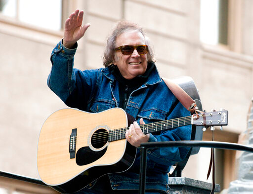 FILE - Don McLean rides a float in the Macy's Thanksgiving Day Parade in New York. Feb. 22, 2019. For all those fans of the iconic song &quot;American Pie&quot; who have sometimes wondered about the lyrics they are singing loudly, singer-songwriter Don McLean shares the secrets in the new full-length feature documentary, &quot;The Day the Music Died: The Story of Don McLean's 'American Pie.'&quot;. (AP Photo/Charles Sykes, File)