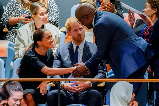 Meghan, Duchess of Sussex, left, shakes hands with Mondli Gungubele, Minister in the Presidency of South Africa, right, alongside Britain's Prince Harry, center, inside the U.N. General Assembly at its annual celebration of Nelson Mandela International Day, Monday, July 18, 2022, at United Nations headquarters.  (AP Photo/John Minchillo)