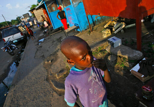 FILE - A young boy stands in the streets of Monrovia, Liberia, Nov. 20, 2007. Liberia is celebrating two major anniversaries this year &mdash; 200 years ago freed slaves from the U.S. arrived here and 25 years later they declared the country to be independent. Amid the festivities for Independence Day on Tuesday July 26, 2022, many Liberians say the West African country's promise is unfulfilled and too many of its people still live in poverty. (AP Photo/Jerome Delay, File)