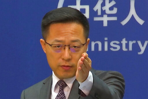 Chinese Foreign Ministry spokesperson Zhao Lijian gestures during a news conference at the Ministry of Foreign Affairs in Beijing, Wednesday, July 27, 2022. China's government on Wednesday rejected as a &quot;political lie&quot; a report by The Wall Street Journal that Beijing tried to recruit informants in the Federal Reserve system to obtain U.S. economic data. (AP Photo/Liu Zheng)